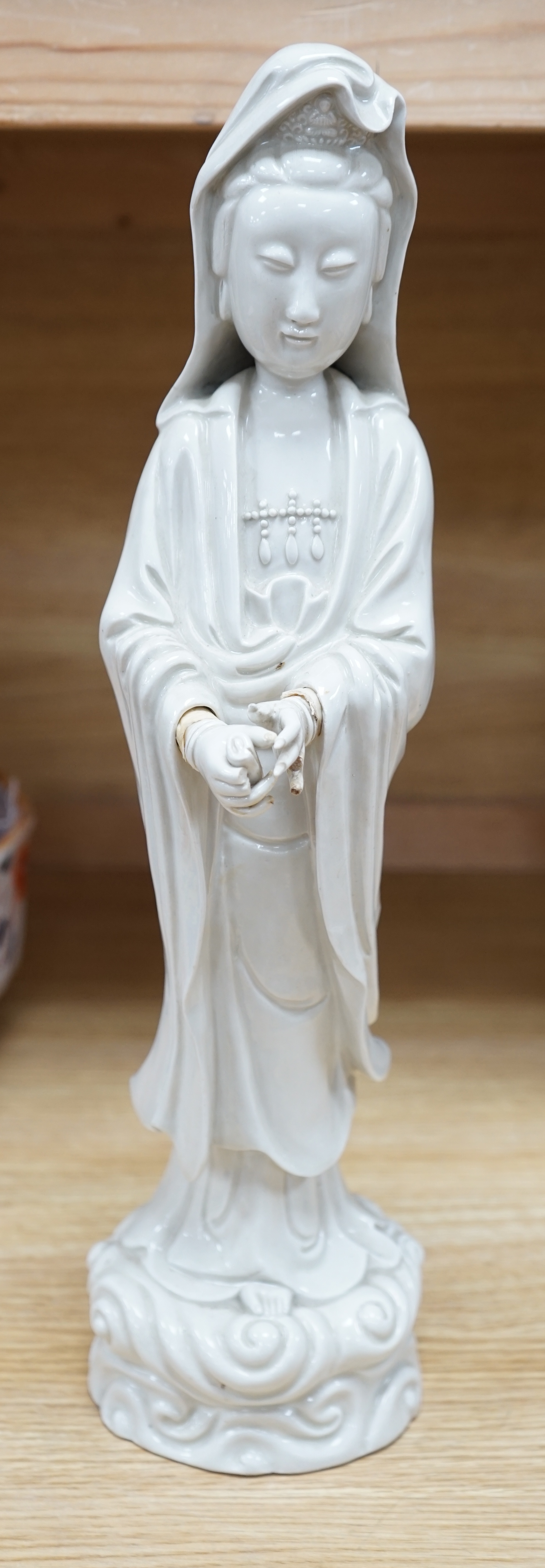 A Chinese blanc de chine figure of Guanyin, early 20th century, 45cm high. Condition - poor to fair, a number of fingers broken and missing